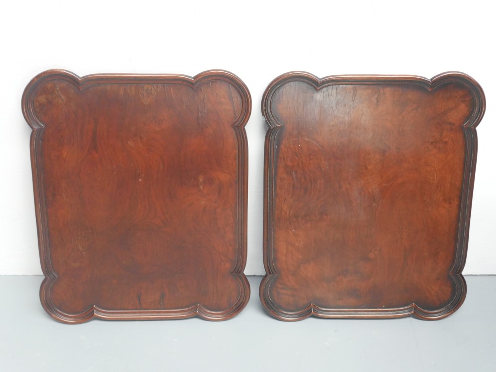 A matching pair of polished warm brown mahogany side tables featuring raised tray-top edges, turned legs, and curved X-stretchers. View XX