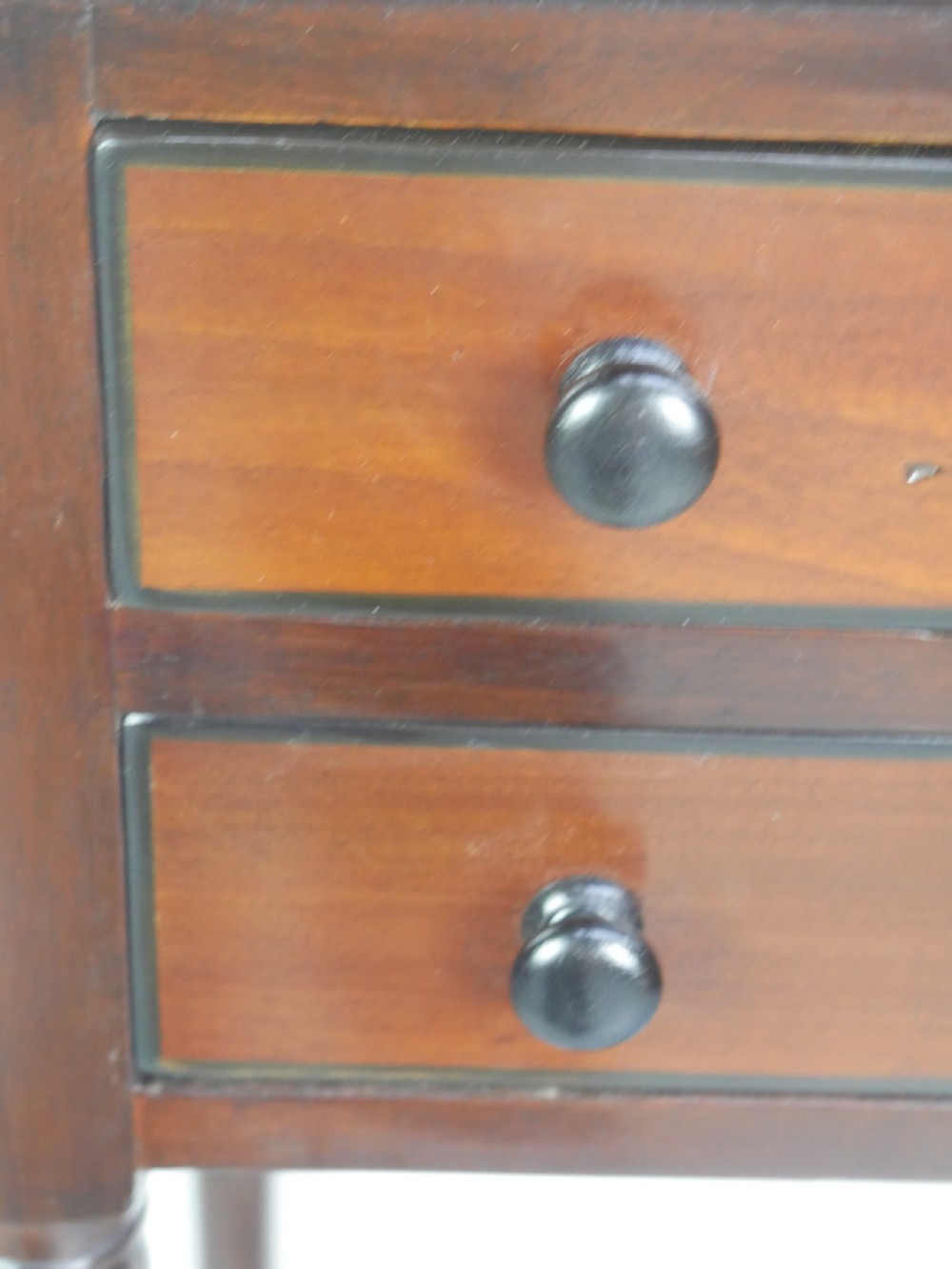 A pair of tall slim dark mahogany bedside tables featuring tray tops, two drawers with black knobs, turned legs, and curved X-frame stretchers. View XI