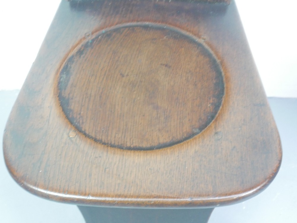 A pair of dark brown 18th-century oak sgabello hall chairs with shaped backrests and trestle bases set against a plain white background. View VIII