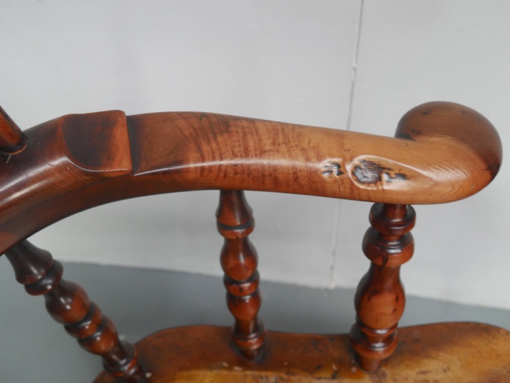 A 19th-century yewwood Windsor armchair featuring a high hoop back, central pierced fretwork splat, turned spindles, and a shaped wooden seat. View IX