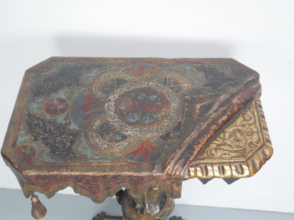 A 19th-century carved polychrome and gilded wooden Venetian side table depicting a figural stand supporting a draped canopy top with hanging tassels. View II