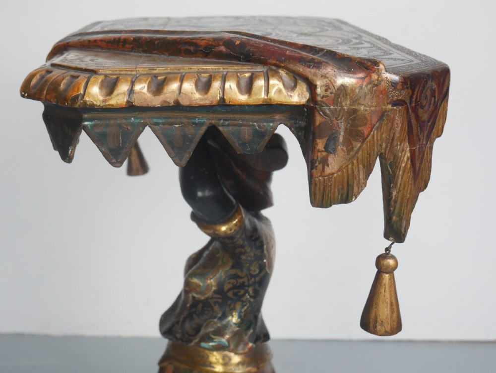 A 19th-century carved polychrome and gilded wooden Venetian side table depicting a figural stand supporting a draped canopy top with hanging tassels. View XII