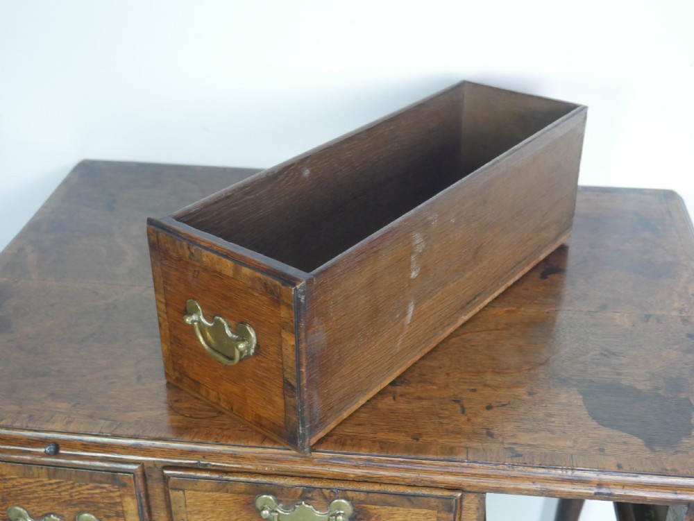 An eighteenth-century Georgian oak lowboy table featuring three drawers with brass handles, a shaped apron, and four cabriole legs ending in pad feet. View VII