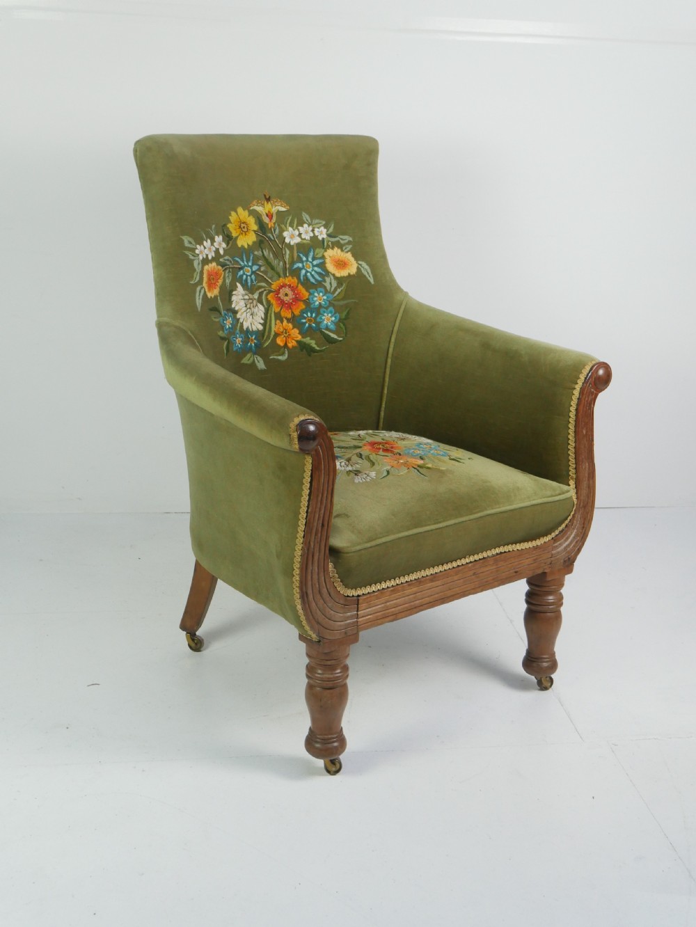 A Regency period style armchair upholstered in olive green velvet with floral needlepoint embroidery on the backrest and seat cushion. View III