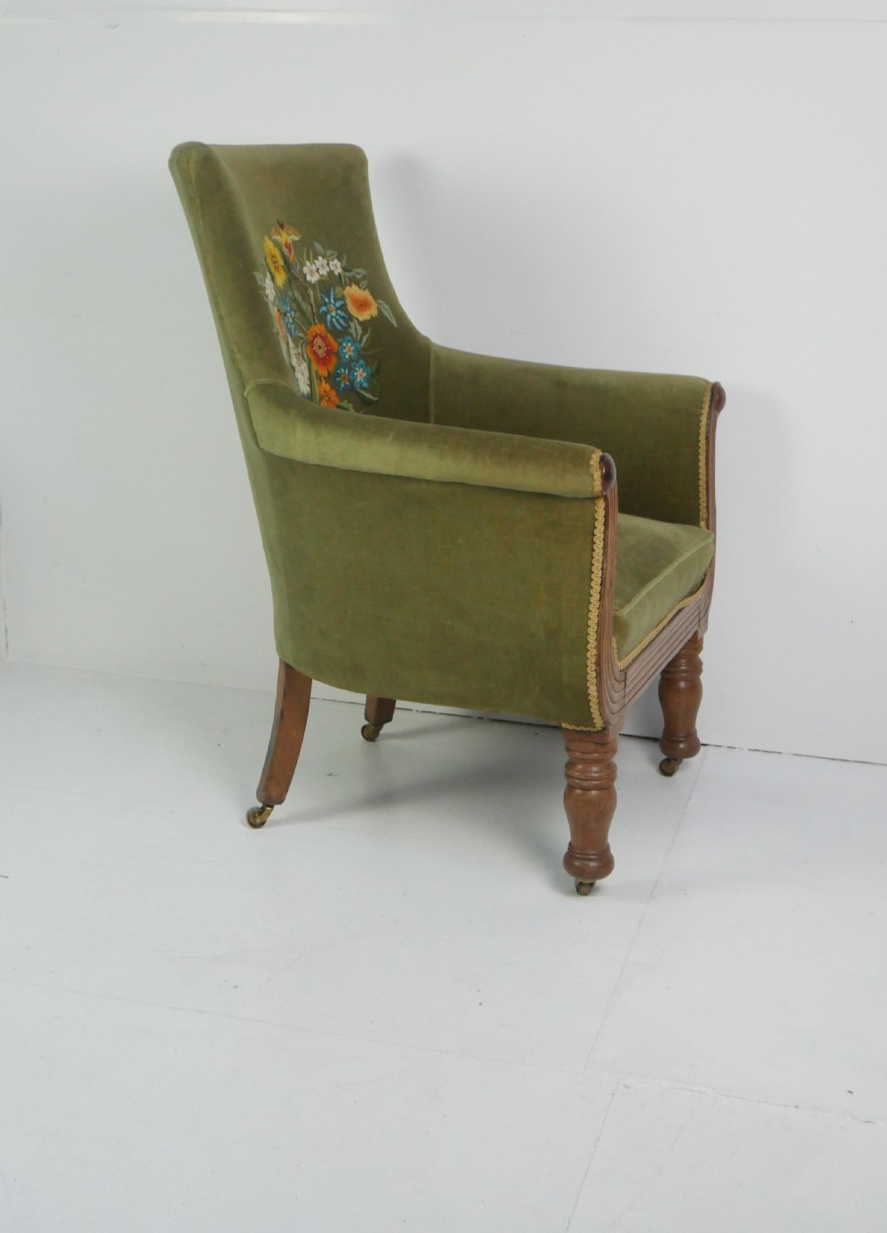 A Regency period style armchair upholstered in olive green velvet with floral needlepoint embroidery on the backrest and seat cushion. View VII