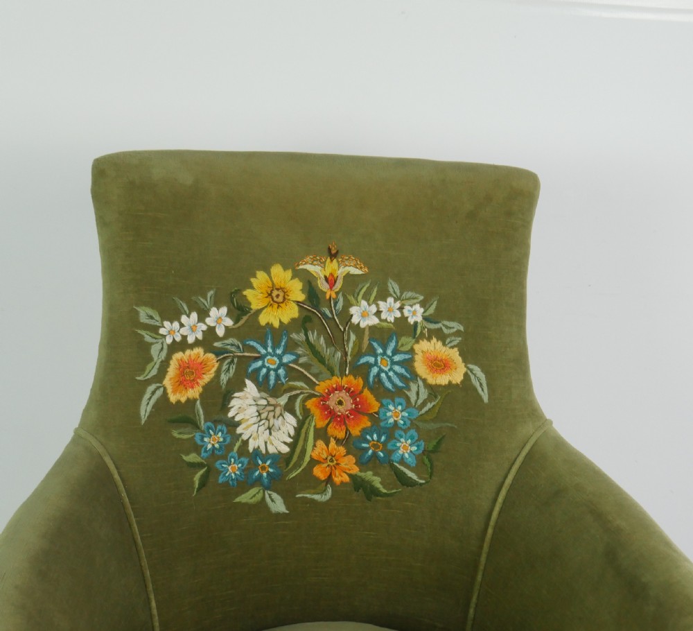 A Regency period style armchair upholstered in olive green velvet with floral needlepoint embroidery on the backrest and seat cushion. View IX