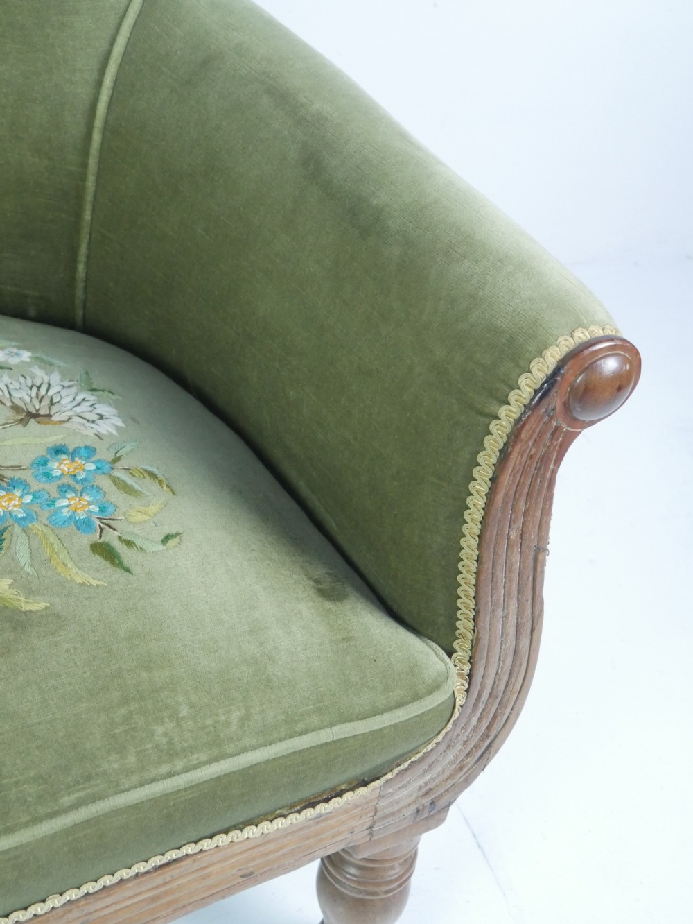 A Regency period style armchair upholstered in olive green velvet with floral needlepoint embroidery on the backrest and seat cushion. View X