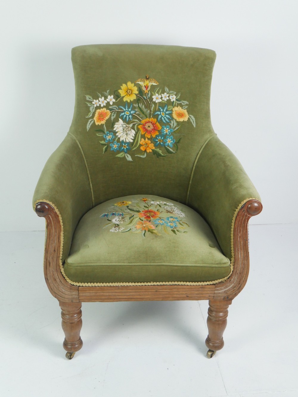 A Regency period style armchair upholstered in olive green velvet with floral needlepoint embroidery on the backrest and seat cushion. View XII