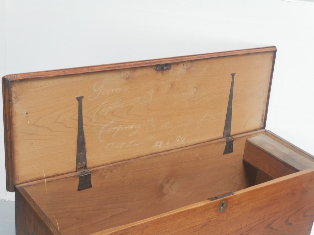 An antique timber six-plank coffer crafted from warm brown elm featuring a central brass keyhole escutcheon and shaped bootjack side panels. View III