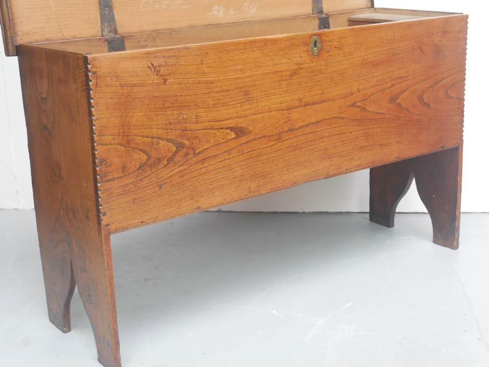 An antique timber six-plank coffer crafted from warm brown elm featuring a central brass keyhole escutcheon and shaped bootjack side panels. View V