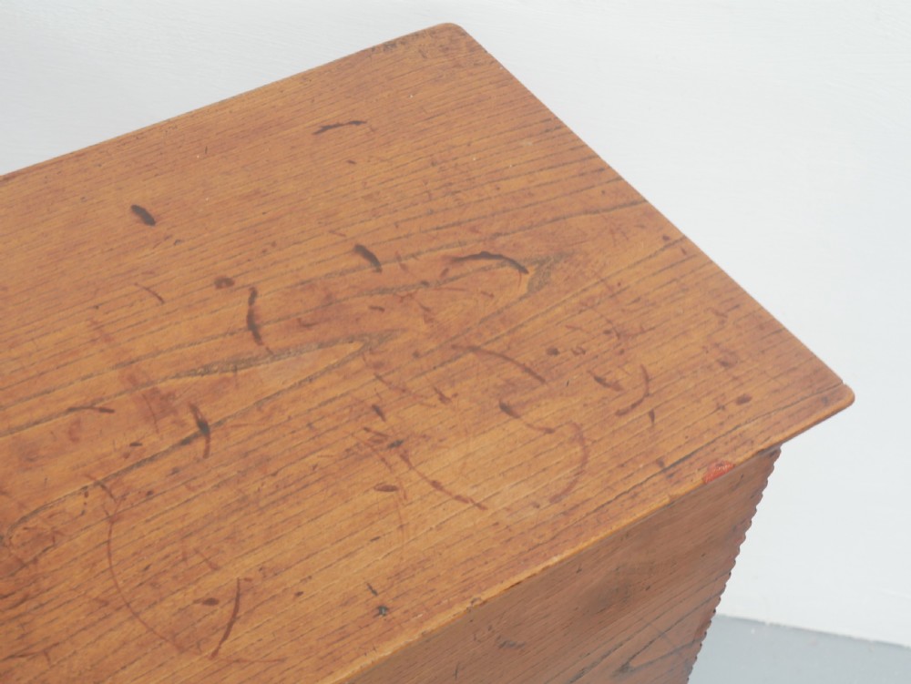 An antique timber six-plank coffer crafted from warm brown elm featuring a central brass keyhole escutcheon and shaped bootjack side panels. View X