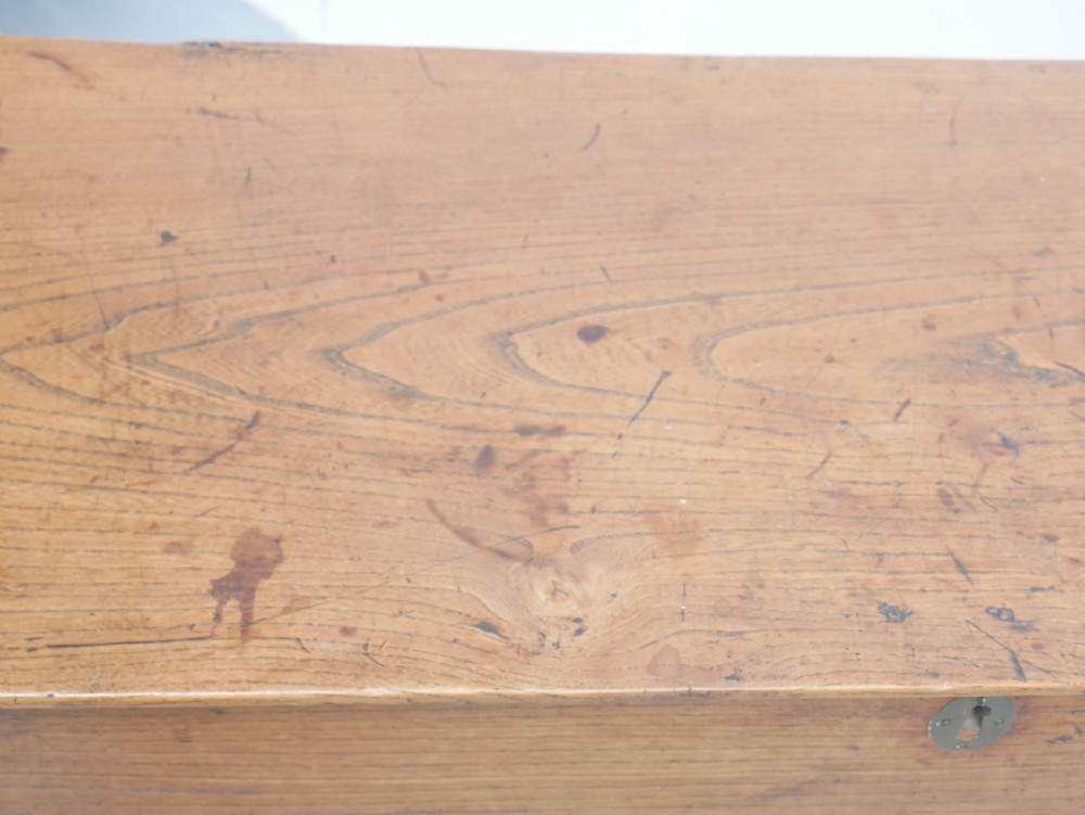 An antique timber six-plank coffer crafted from warm brown elm featuring a central brass keyhole escutcheon and shaped bootjack side panels. View XI