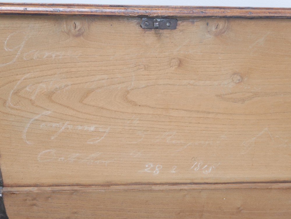 An antique timber six-plank coffer crafted from warm brown elm featuring a central brass keyhole escutcheon and shaped bootjack side panels. View XIII