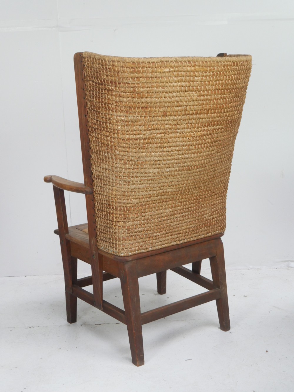 A traditional full-sized Scottish Orkney armchair featuring a timber oak frame, flat wooden armrests, a rush seat, and a tall hand-woven oat straw backrest. View III