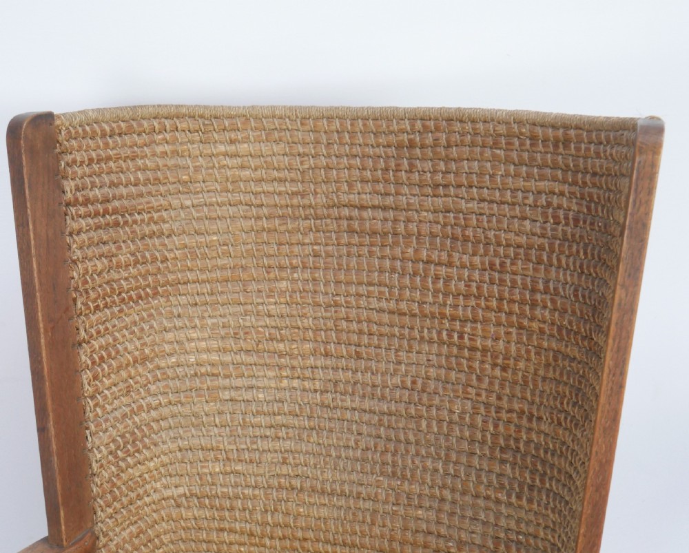 A traditional full-sized Scottish Orkney armchair featuring a timber oak frame, flat wooden armrests, a rush seat, and a tall hand-woven oat straw backrest. View V