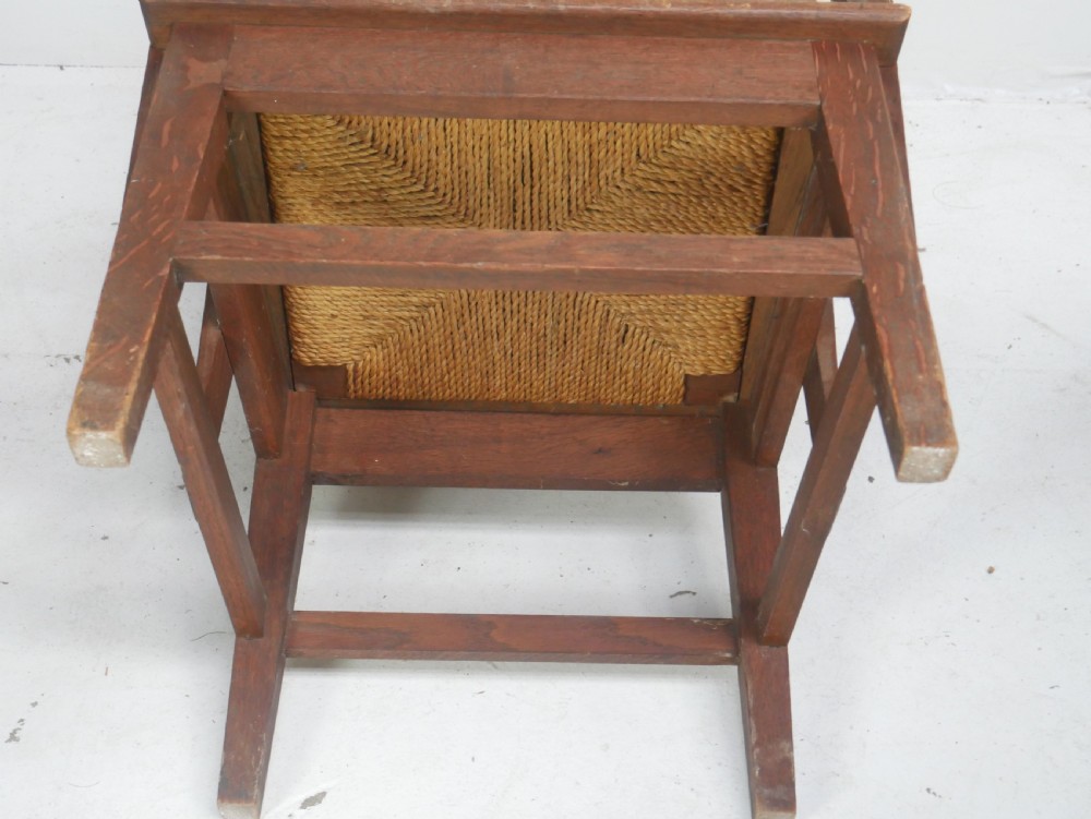 A traditional full-sized Scottish Orkney armchair featuring a timber oak frame, flat wooden armrests, a rush seat, and a tall hand-woven oat straw backrest. View VII