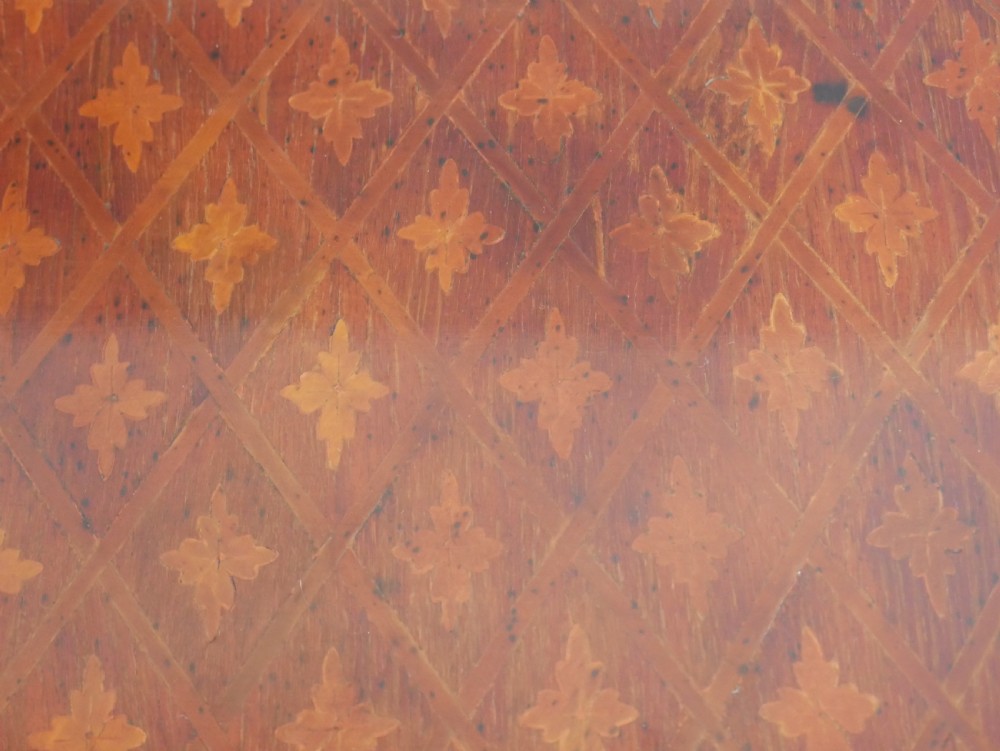 An oval Louis XV style wooden centre table featuring geometric parquetry inlay, a single drawer, a lower tier, cabriole legs, and ornate gilt metal mounts. View VIII