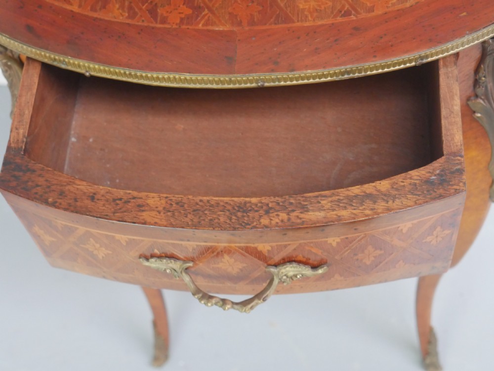An oval Louis XV style wooden centre table featuring geometric parquetry inlay, a single drawer, a lower tier, cabriole legs, and ornate gilt metal mounts. View IX
