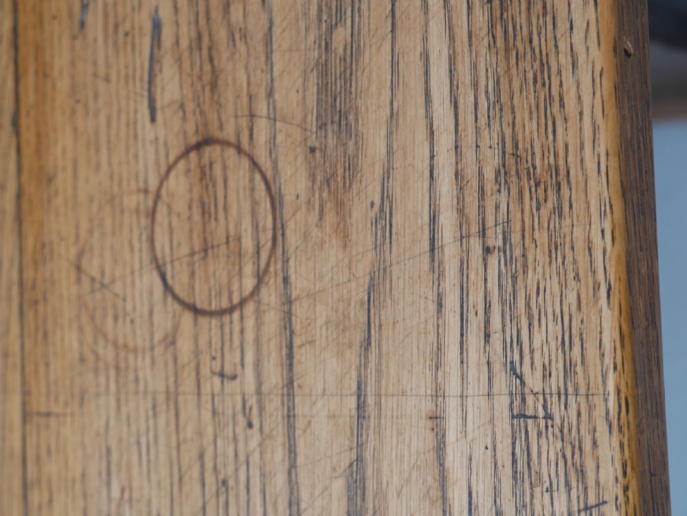 A long solid oak refectory dining table featuring a plank top, shaped trestle end supports, and a central pegged stretcher. View VIII