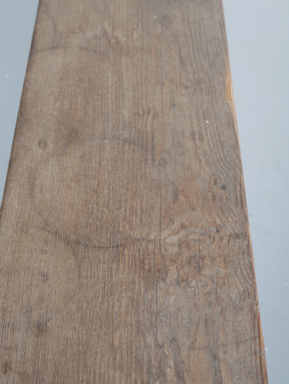 A pair of long, dark brown rustic pine benches featuring solid plank tops and trestle-style slab legs with arched cutouts. View IV