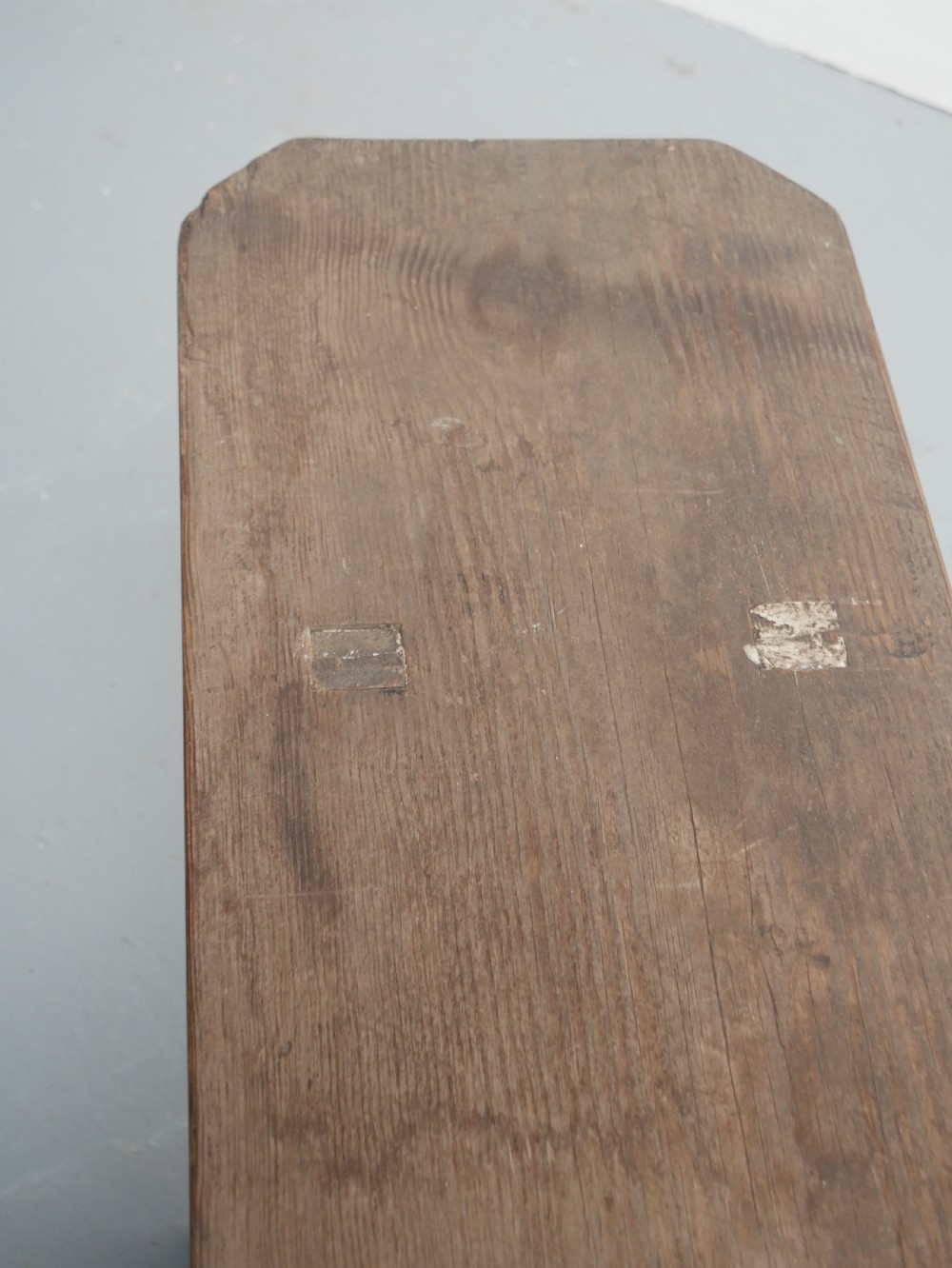 A pair of long, dark brown rustic pine benches featuring solid plank tops and trestle-style slab legs with arched cutouts. View V