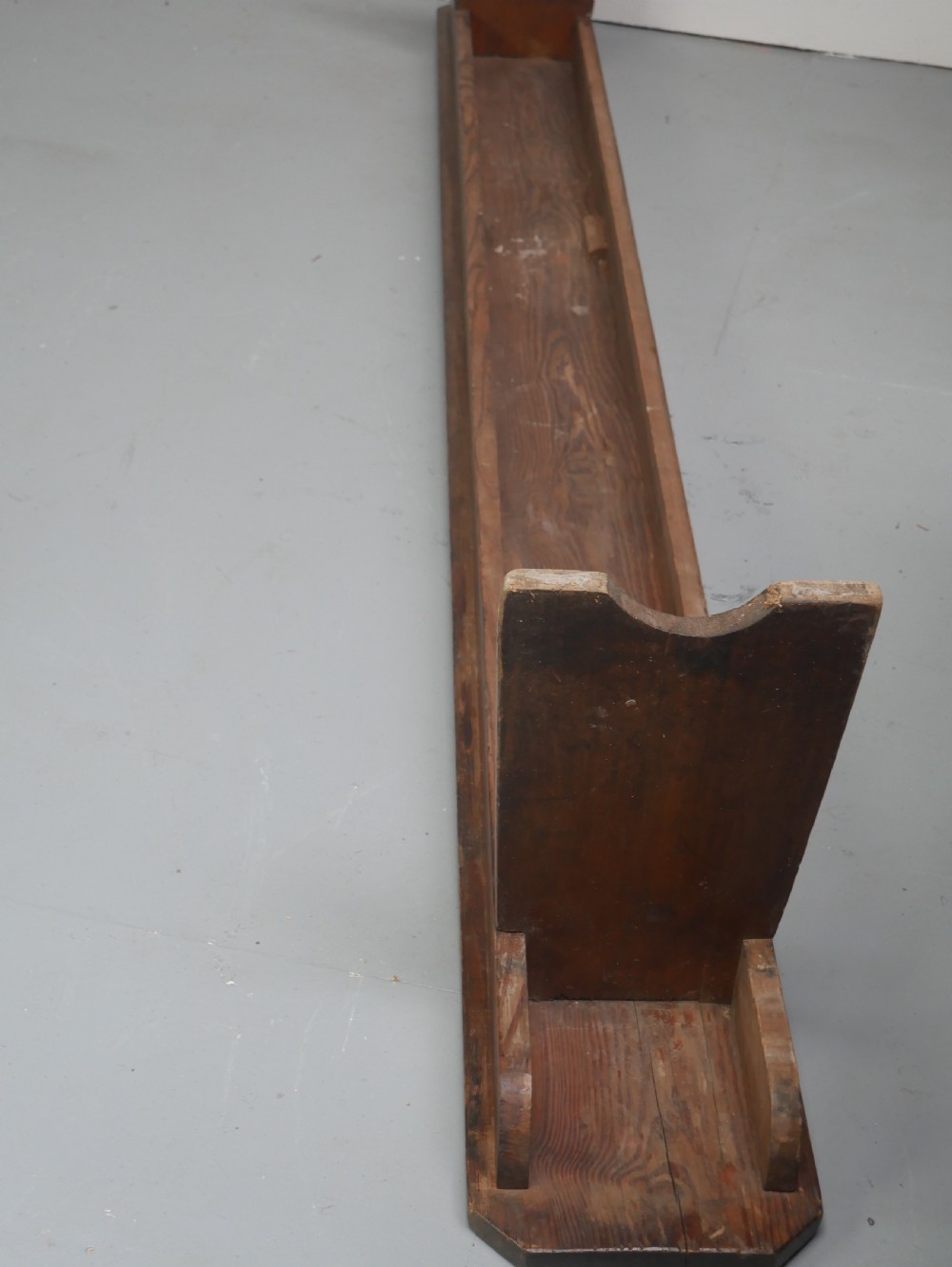A pair of long, dark brown rustic pine benches featuring solid plank tops and trestle-style slab legs with arched cutouts. View XI