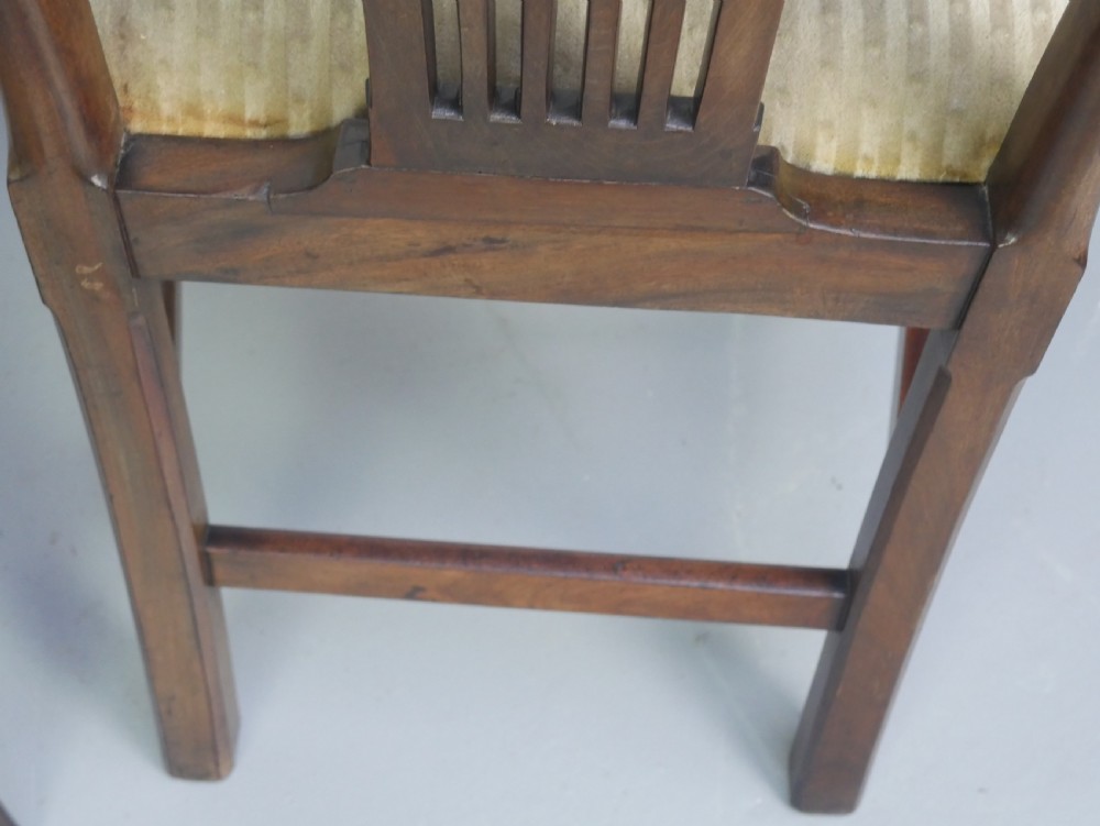 A pair of antique Georgian mahogany side chairs featuring pierced urn carved splats, arched backs, and upholstered seats supported by fluted front legs. View VIII