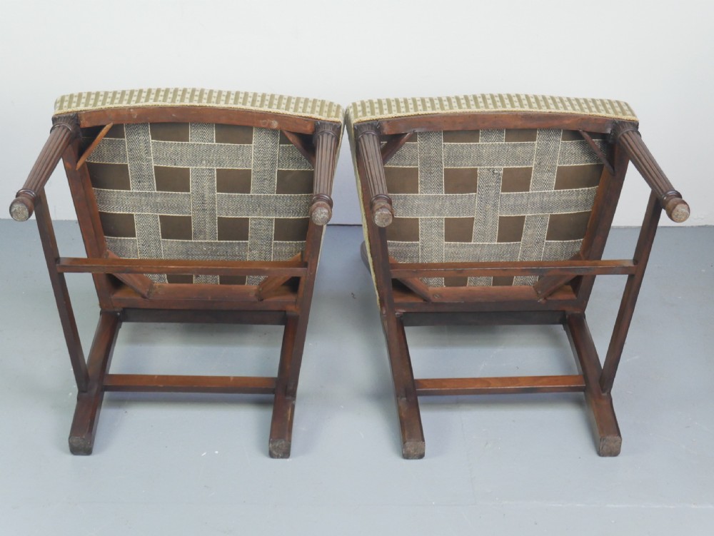 A pair of antique Georgian mahogany side chairs featuring pierced urn carved splats, arched backs, and upholstered seats supported by fluted front legs. View XI