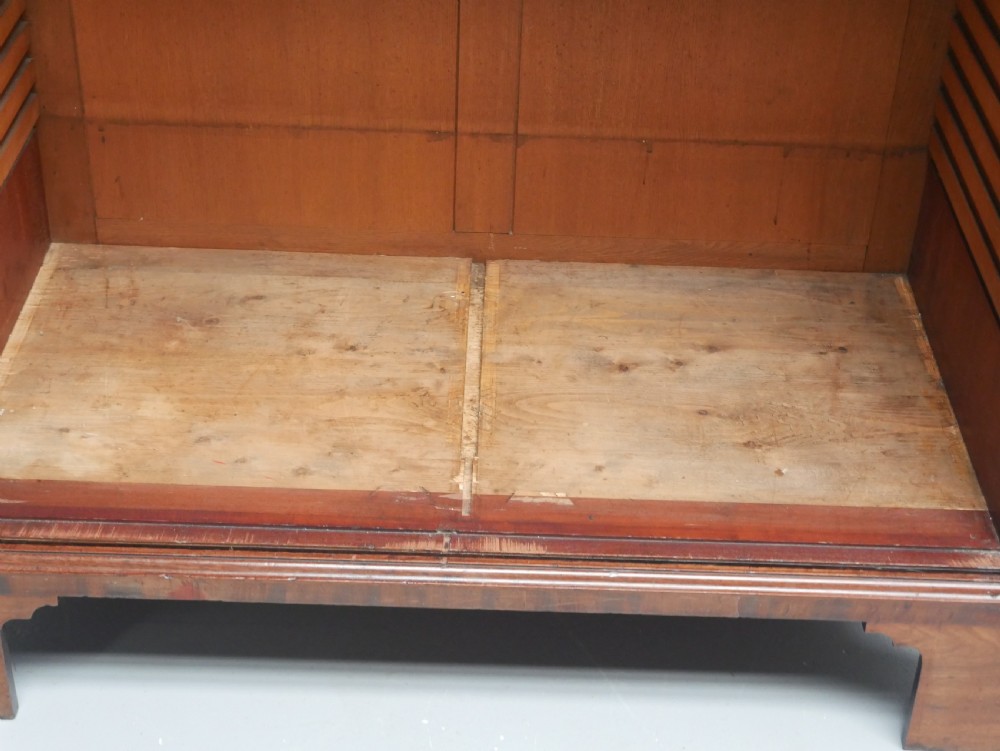 A Georgian mahogany double-door hanging wardrobe featuring shaped curvilinear door panels and sturdy bracket feet. View VI