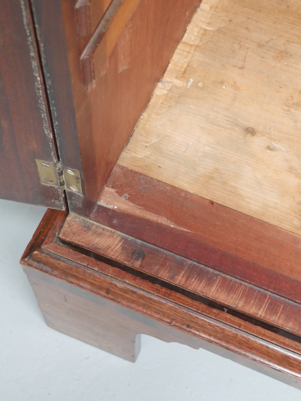 A Georgian mahogany double-door hanging wardrobe featuring shaped curvilinear door panels and sturdy bracket feet. View VII