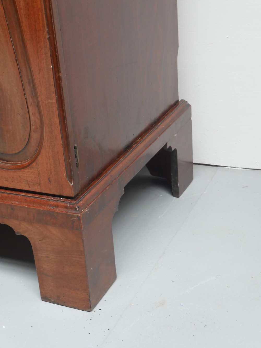 A Georgian mahogany double-door hanging wardrobe featuring shaped curvilinear door panels and sturdy bracket feet. View IX