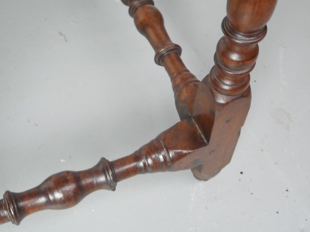 An 18th-century fruitwood side table featuring a single drawer with two brass teardrop handles, slender turned legs, and lower connecting stretchers. View VII