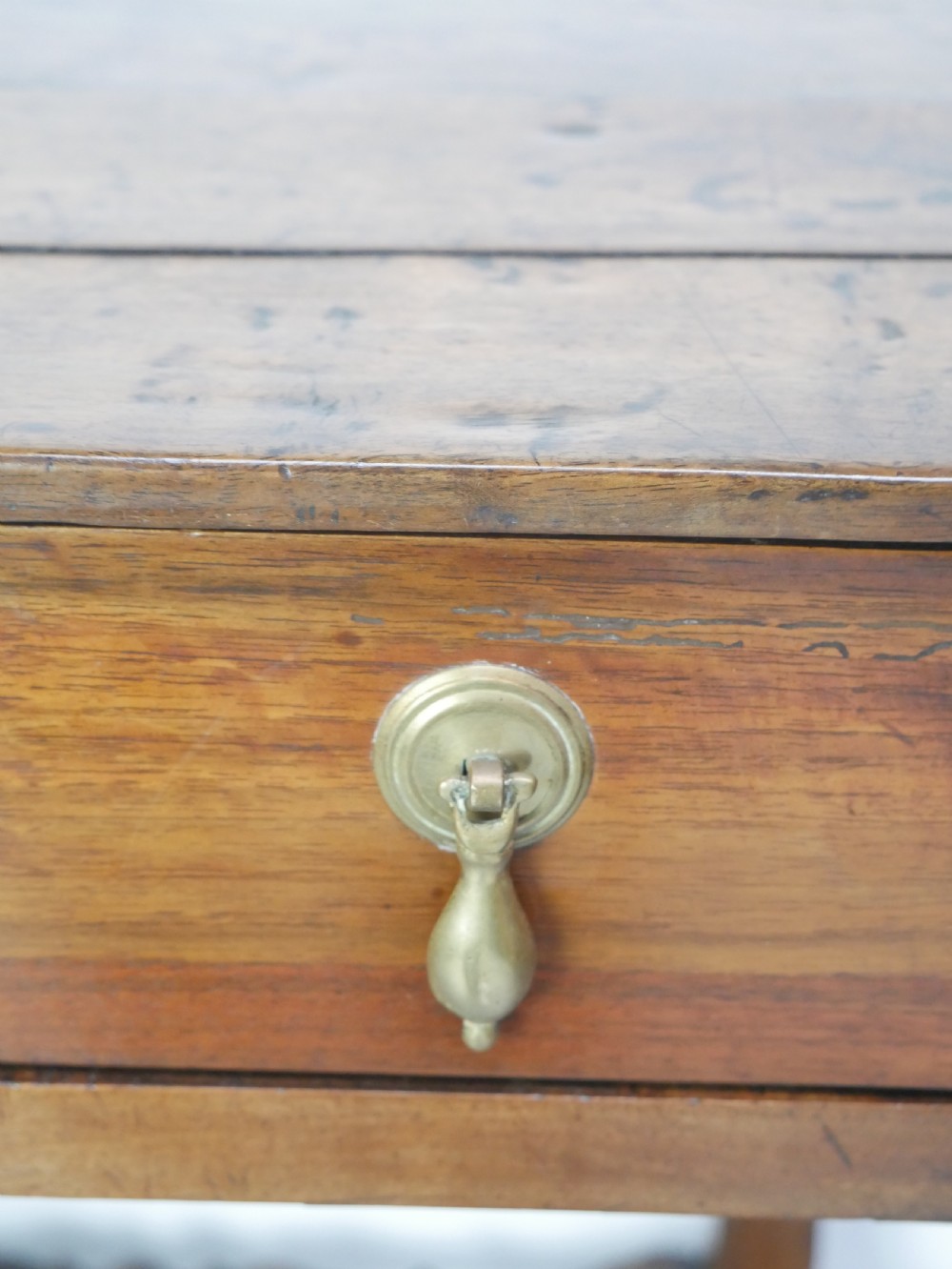 An 18th-century fruitwood side table featuring a single drawer with two brass teardrop handles, slender turned legs, and lower connecting stretchers. View IX