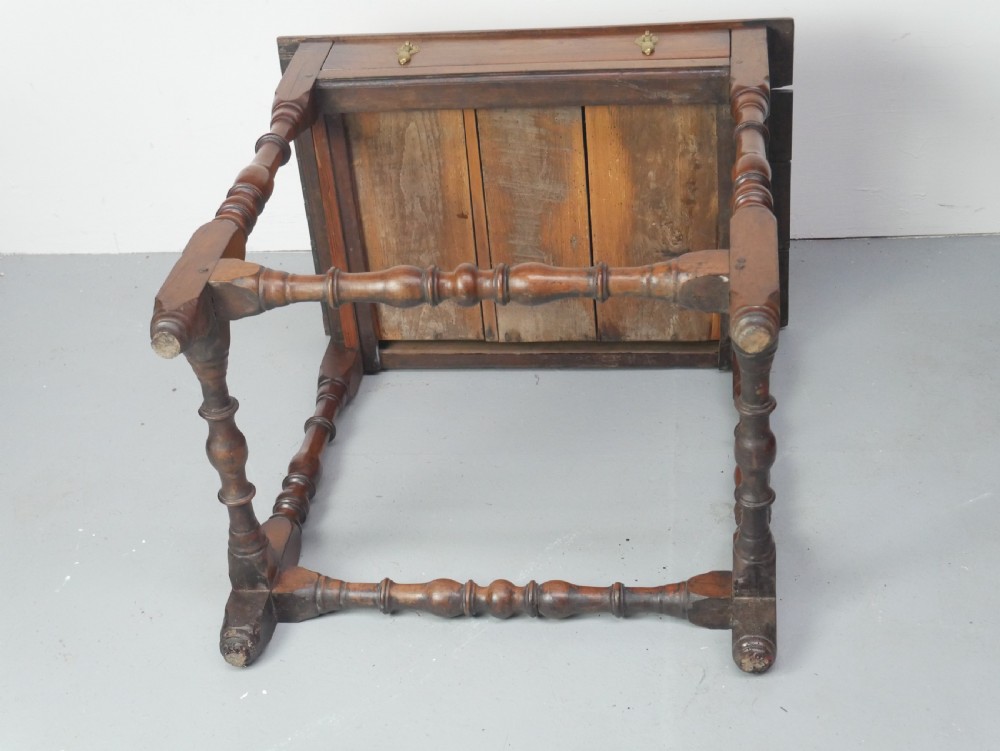 An 18th-century fruitwood side table featuring a single drawer with two brass teardrop handles, slender turned legs, and lower connecting stretchers. View X