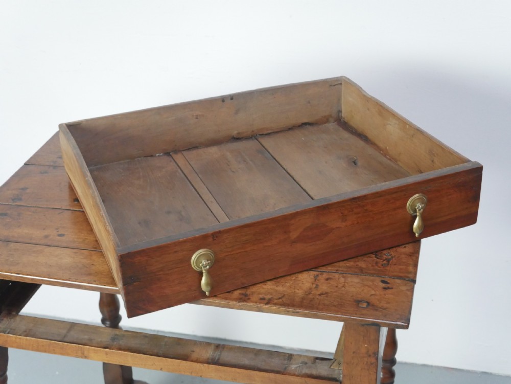 An 18th-century fruitwood side table featuring a single drawer with two brass teardrop handles, slender turned legs, and lower connecting stretchers. View XI