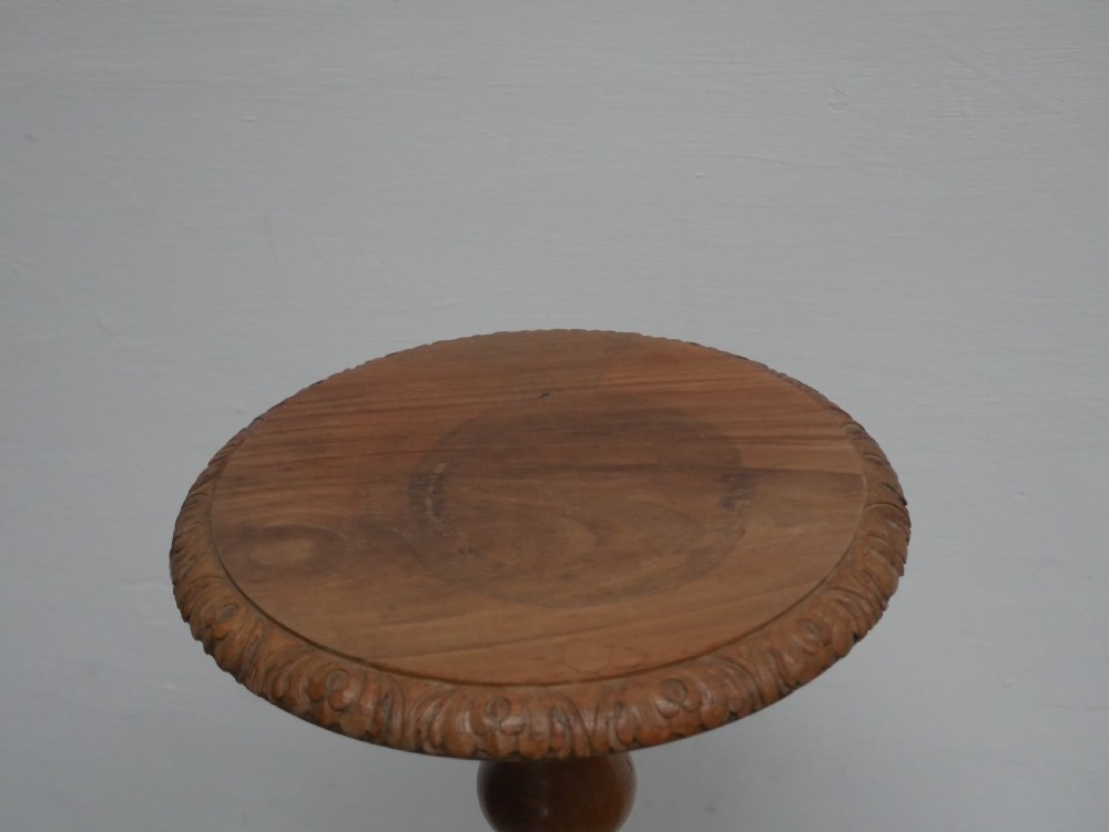 A tall walnut plant stand featuring a carved circular top, turned central column, and tripod base with cabriole legs. View II