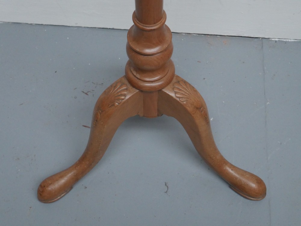 A tall walnut plant stand featuring a carved circular top, turned central column, and tripod base with cabriole legs. View IV