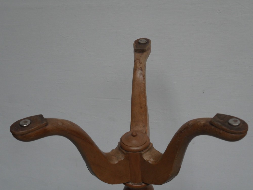A tall walnut plant stand featuring a carved circular top, turned central column, and tripod base with cabriole legs. View VII