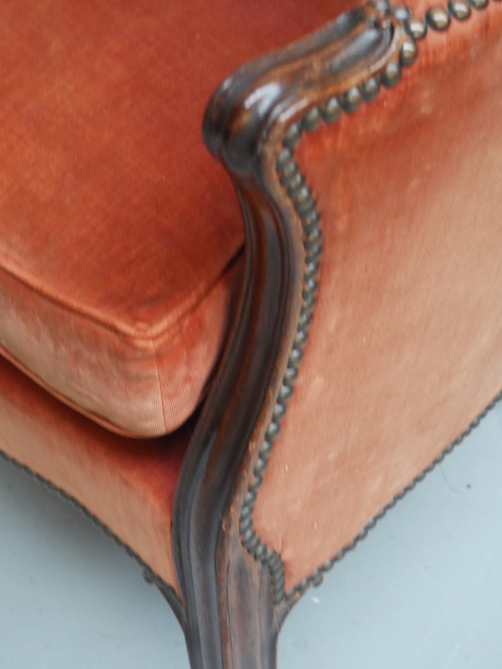 A Georgian high-backed barrel armchair upholstered in burnt orange velvet with brass stud trimming and dark mahogany legs. View VI