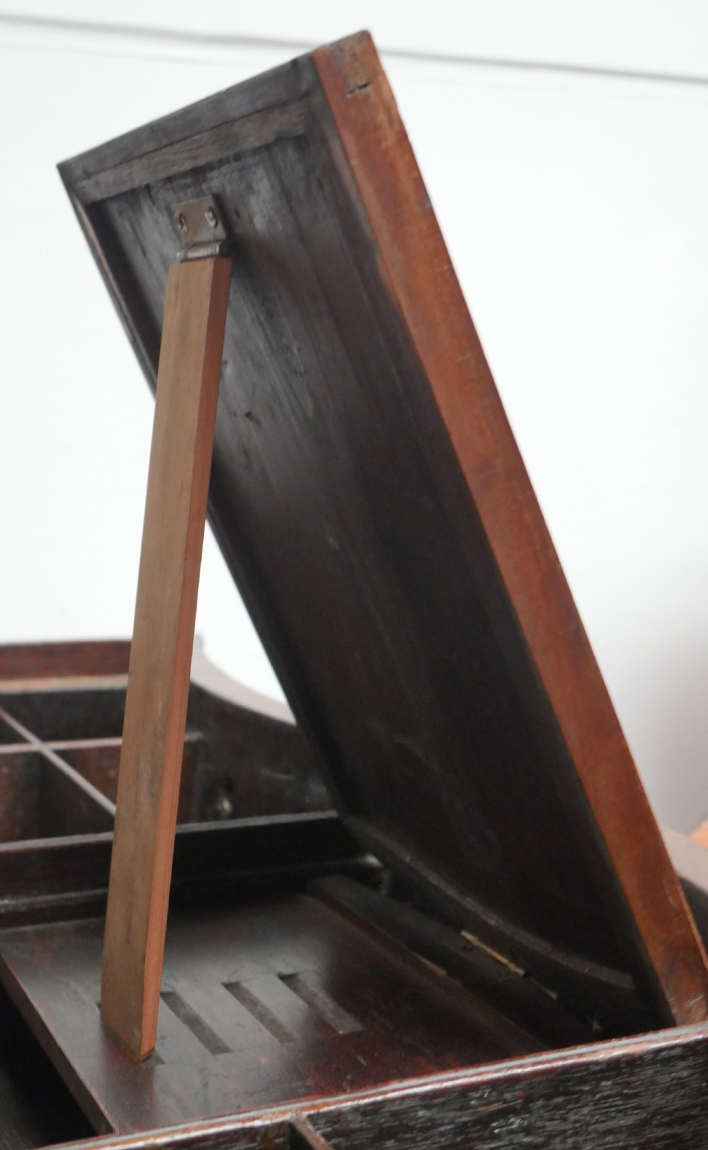 A Georgian mahogany chest of drawers featuring a wave-like serpentine front, four graduated drawers with oval brass handles, and bracket feet. View XII