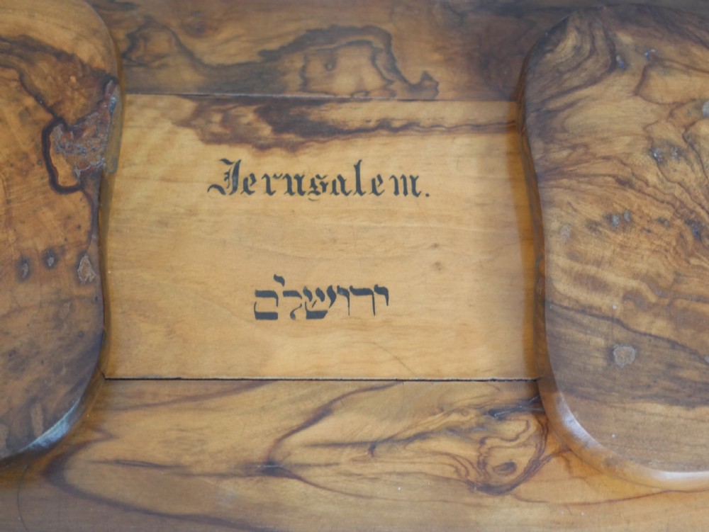 An olive wood extending book slide with hinged rounded ends and black printed text reading Jerusalem in English and Hebrew script. View II