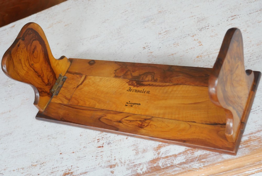 An olive wood extending book slide with hinged rounded ends and black printed text reading Jerusalem in English and Hebrew script. View VII