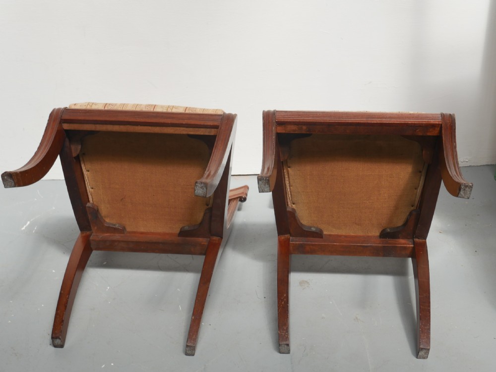 Set of four Regency mahogany dining chairs featuring carved crest rails, horizontal crossbars, and padded seats. View VIII