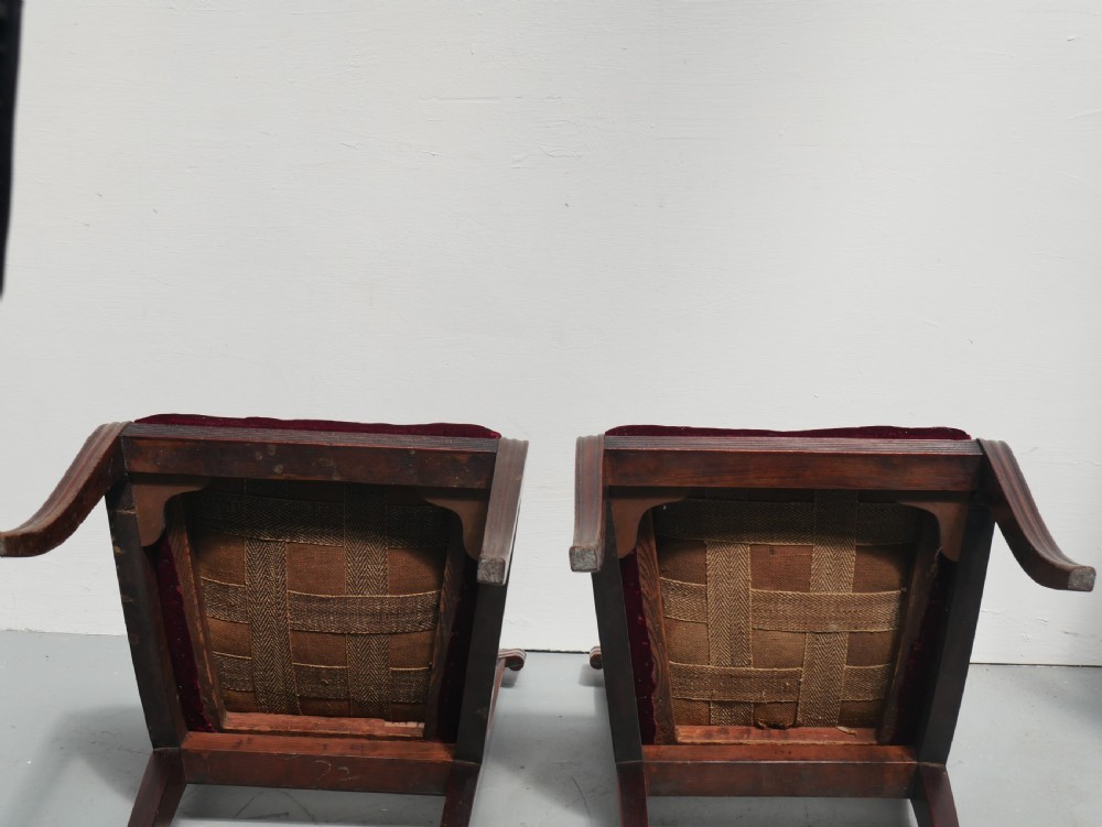 Set of four Regency mahogany dining chairs featuring carved crest rails, horizontal crossbars, and padded seats. View IX