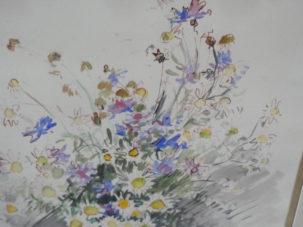 A framed floral watercolour still life painting depicting a bouquet of summer wildflowers in a ceramic jug within a carved giltwood frame. View V