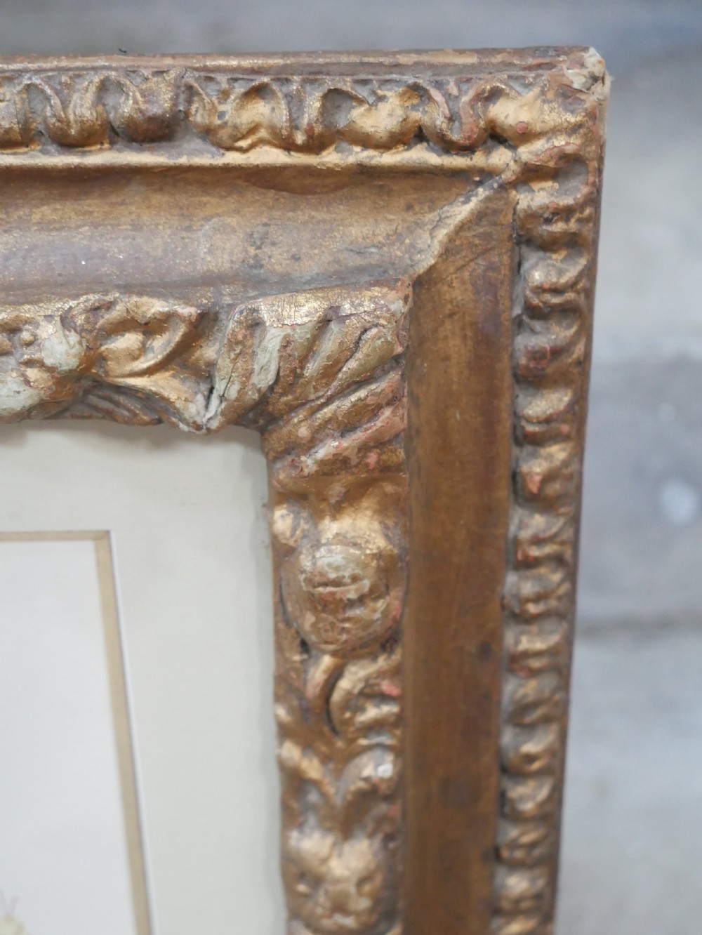 A framed floral watercolour still life painting depicting a bouquet of summer wildflowers in a ceramic jug within a carved giltwood frame. View VI