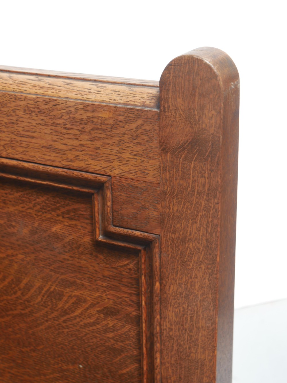 A medium brown oak hall bench featuring a tri-panel backrest, turned armrest supports, and a hinged lid chest base. View IV