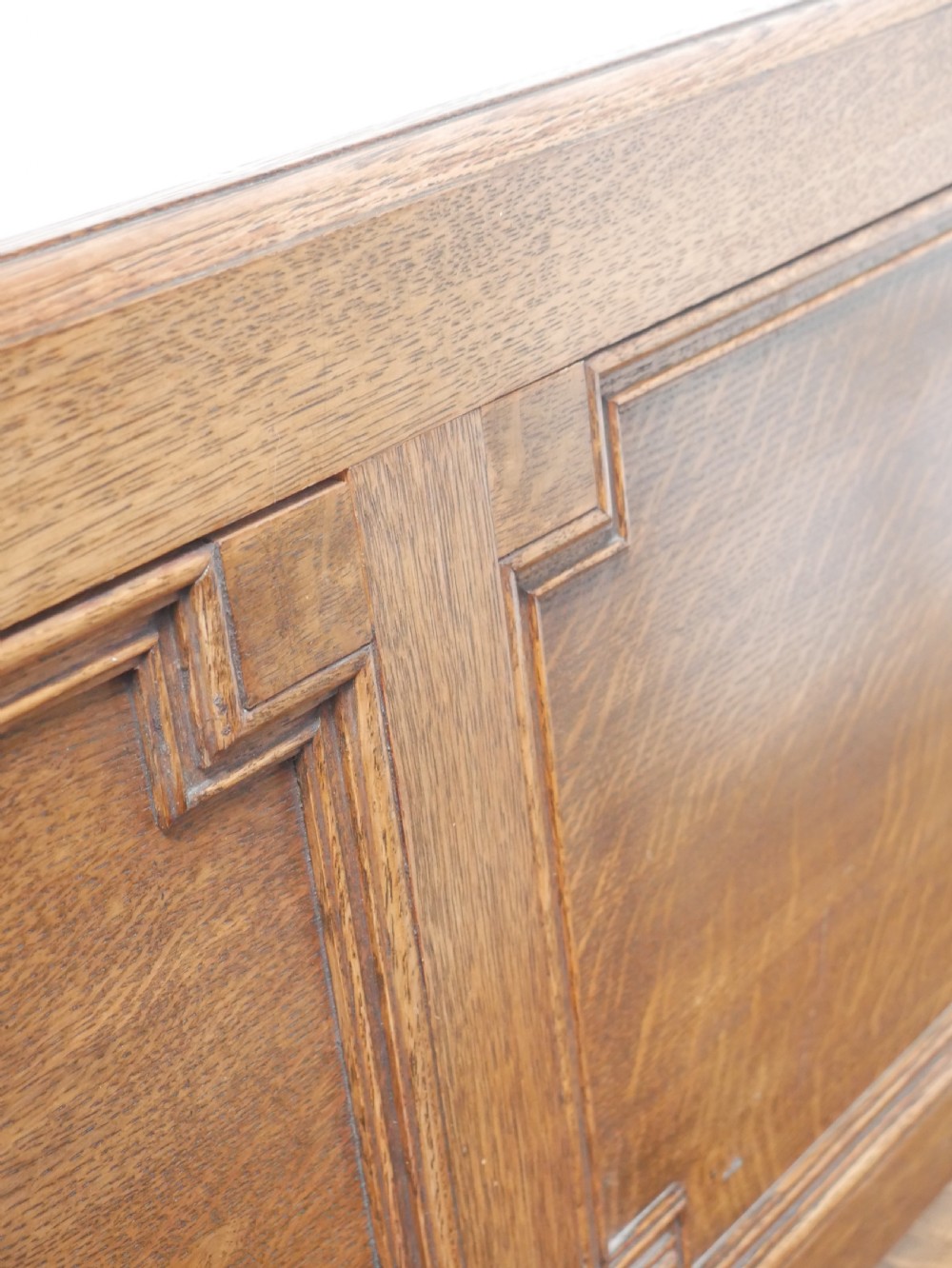 A medium brown oak hall bench featuring a tri-panel backrest, turned armrest supports, and a hinged lid chest base. View XVI