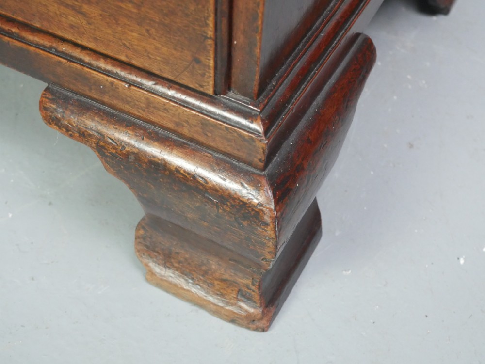 A Georgian mahogany small chest of drawers featuring four graduated drawers, brass swan-neck drop handles, keyhole escutcheons, and shaped bracket feet. View VI