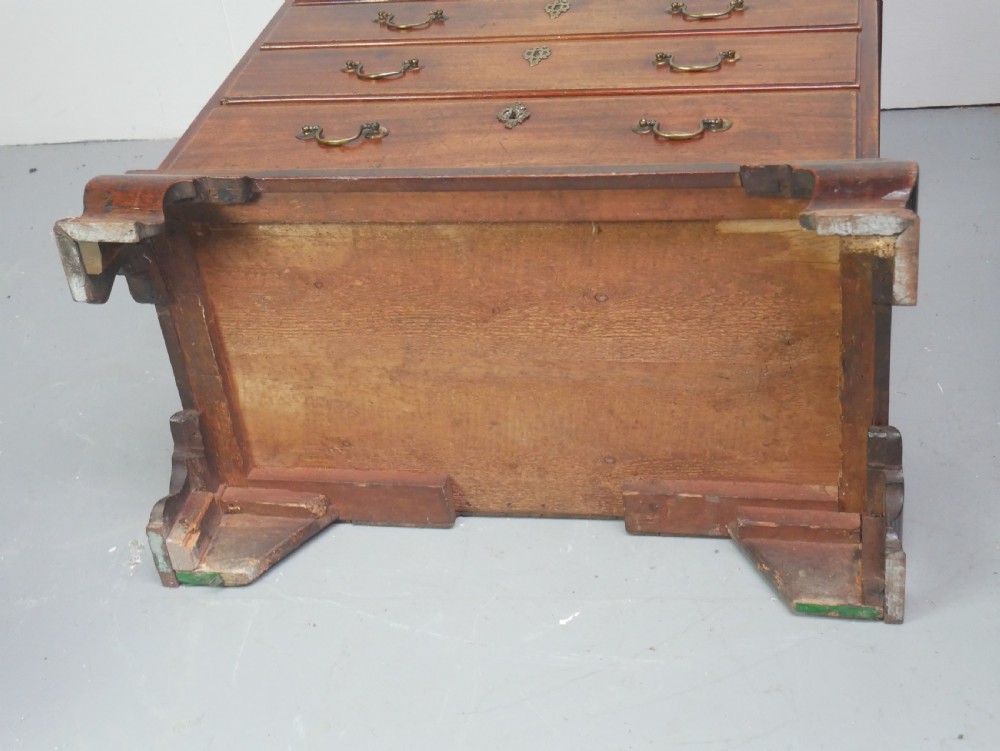 A Georgian mahogany small chest of drawers featuring four graduated drawers, brass swan-neck drop handles, keyhole escutcheons, and shaped bracket feet. View VIII
